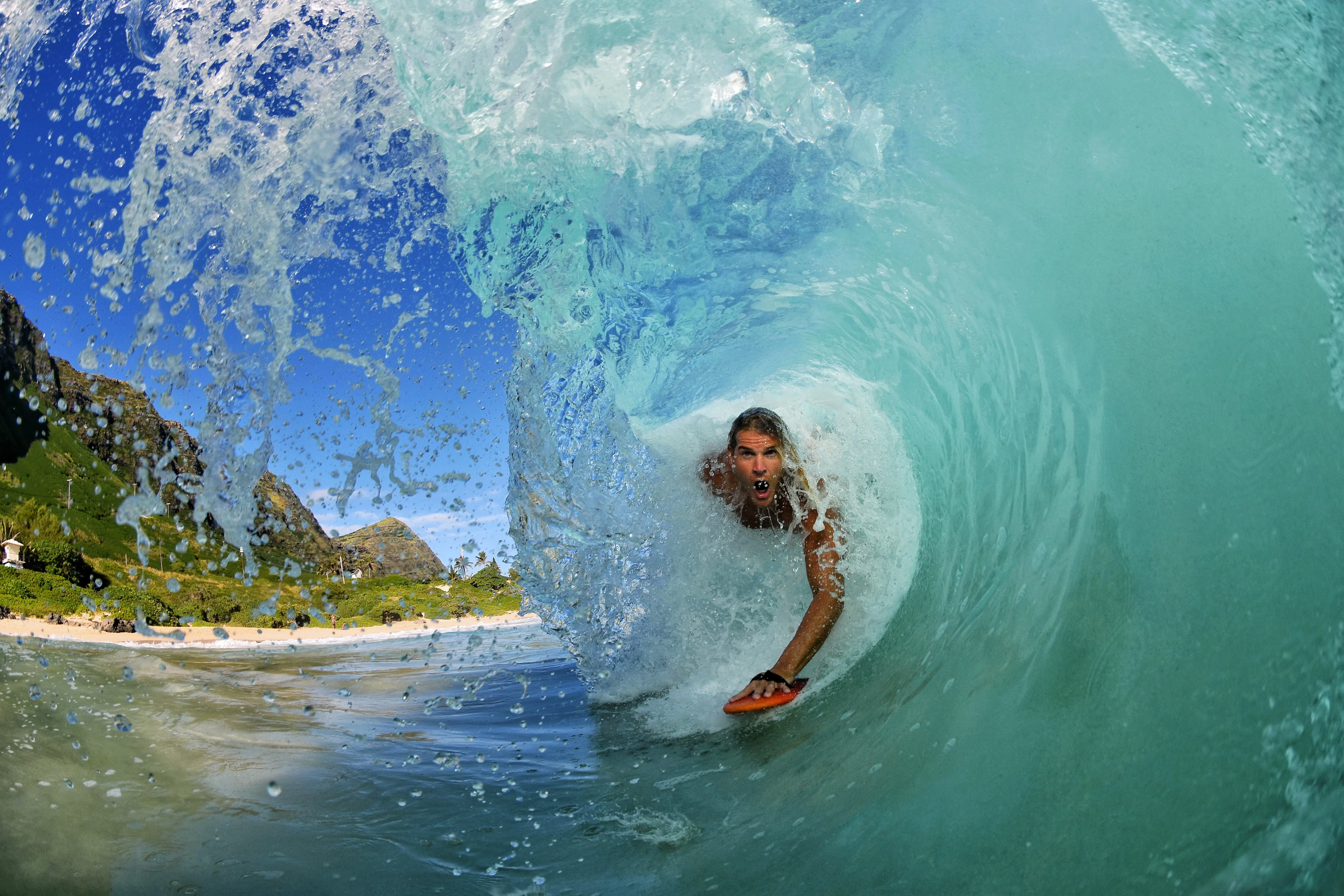 front shot of a surfer coming through a barrell
